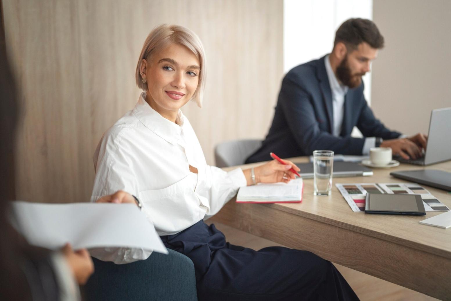 Business professional working with financial documents and laptop